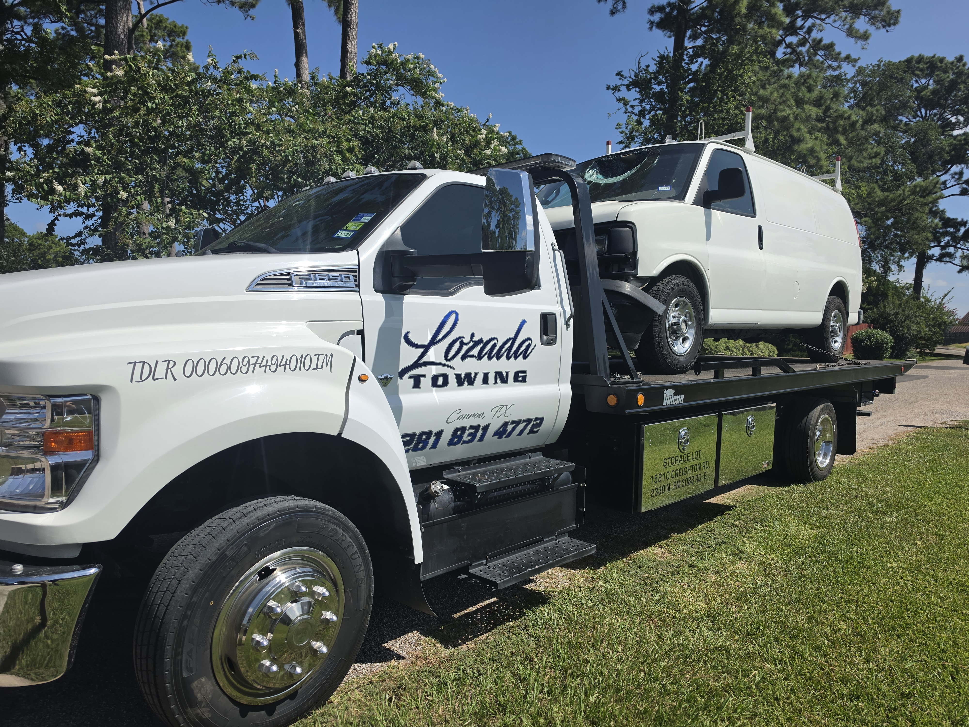 Transporting van on flatbed tow truck